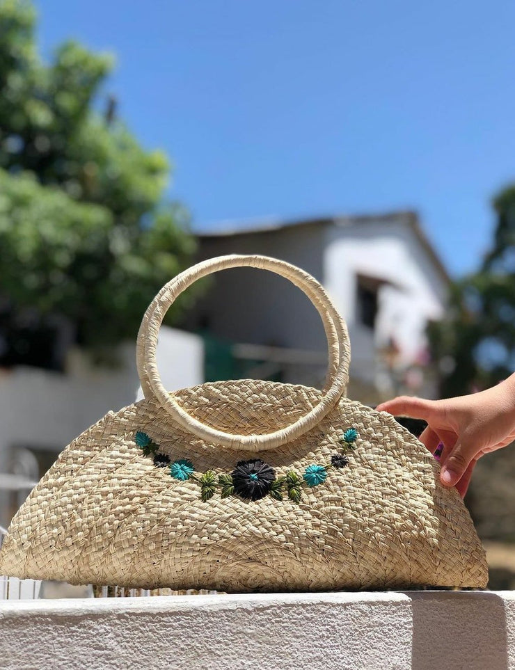 "Empanada" iraca Palm half moon clutch with embroidered accents